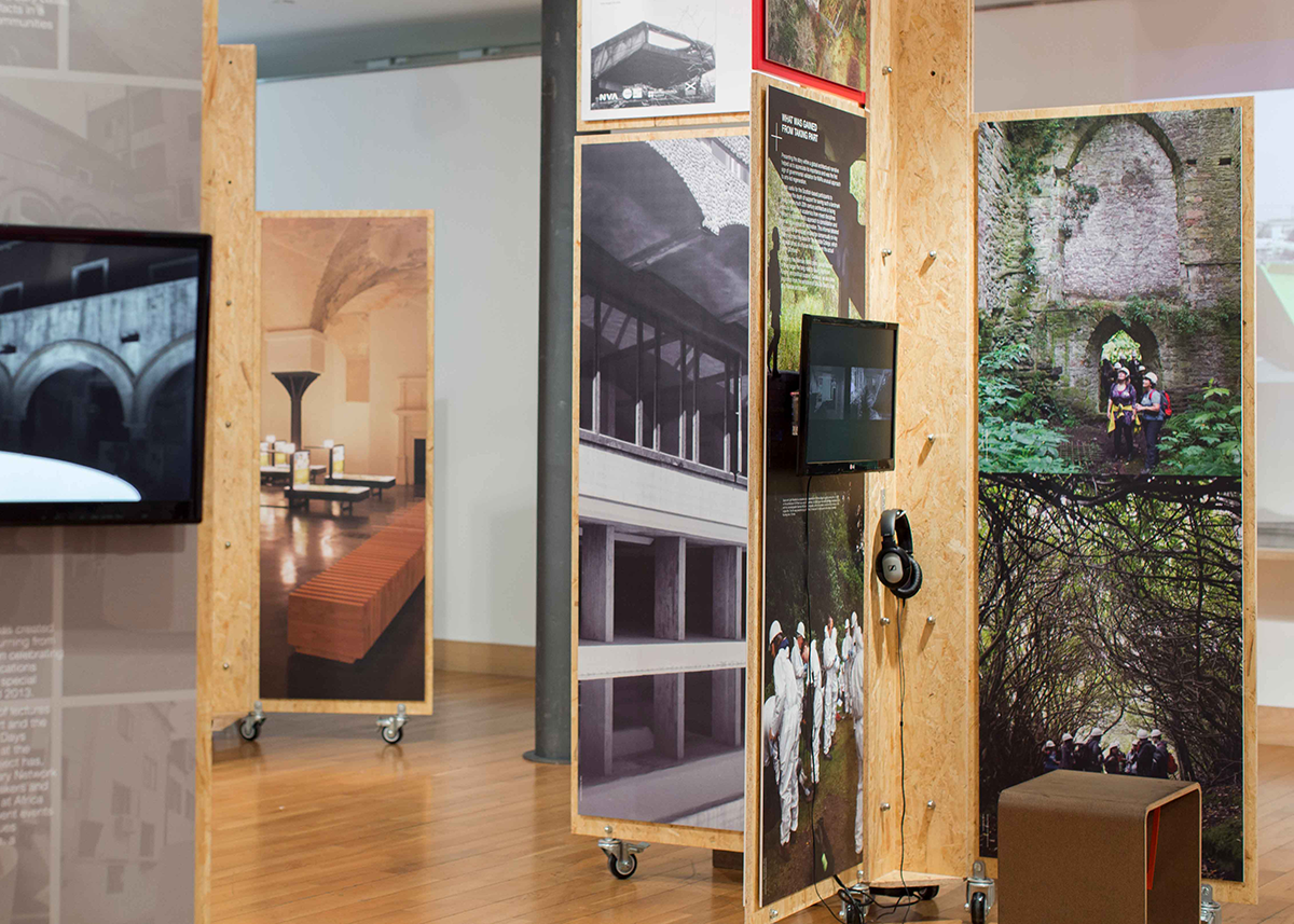 An exhibition featuring wooden panels with photography of landscapes on them