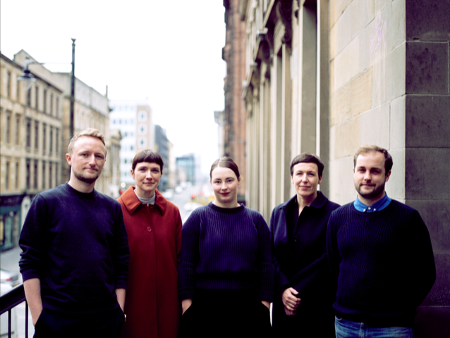 Photo of some of the LUX Scotland team stood outside with sandstone buildings in the background.